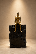 The Quiet Ascent gold and stone seated man figurine statue by Elunne